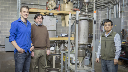 ERC researchers are shown with a battery prototype.