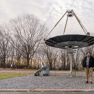 Carlos Romero with the solar thermal concentrator at the Mountaintop Campus of Lehigh University