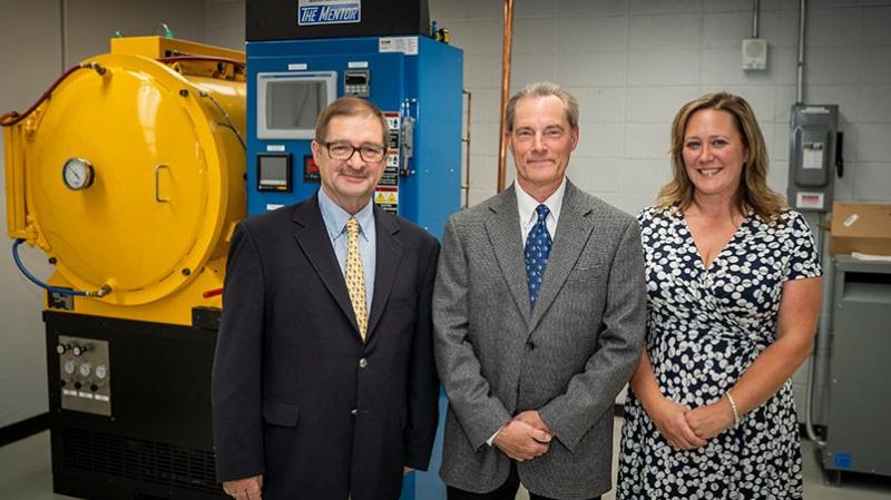 From left, Wojciech Misiolek, Tim Steber, and Laura Moyer with The Mentor, a vacuum heat treating and brazing furnace recently donated by Solar Atmospheres and its CEO and founder, William R. Jones.