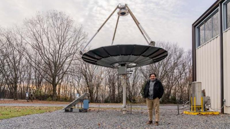 Carlos Romero with the solar thermal concentrator at the Mountaintop Campus of Lehigh University
