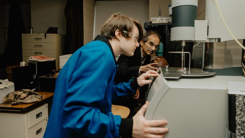 Professor Himanshu Jain, right, works with a student on research. Jain was founding director of I-FMD. Photo by ShotByAsgar